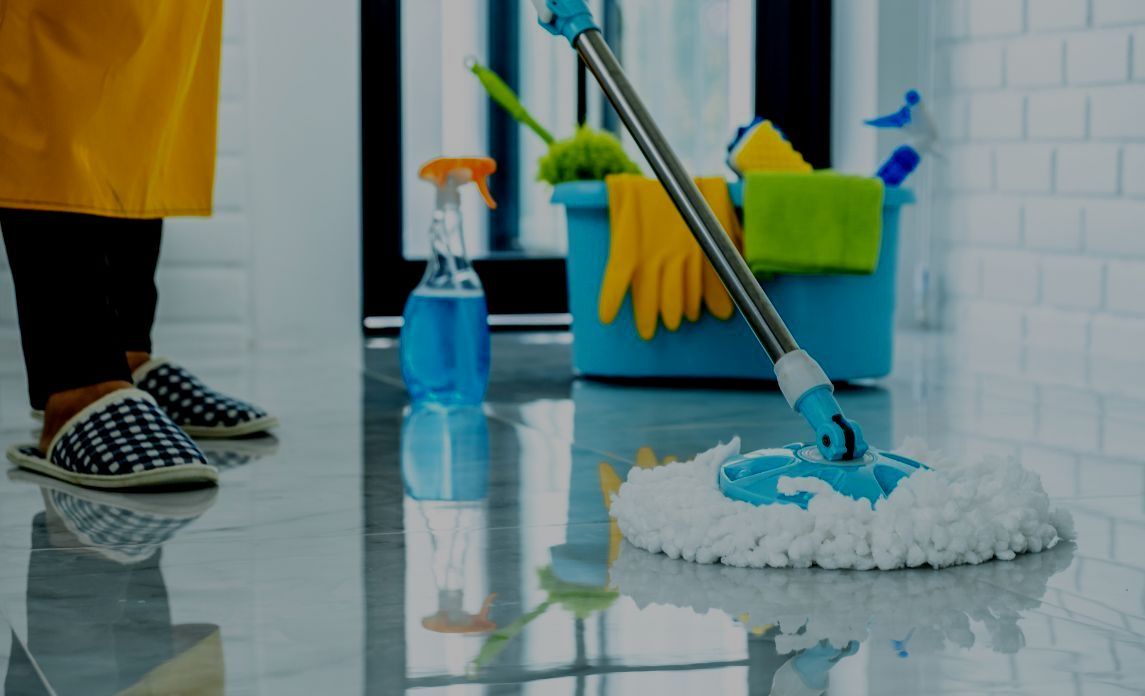 A person is cleaning the floor with a mop.