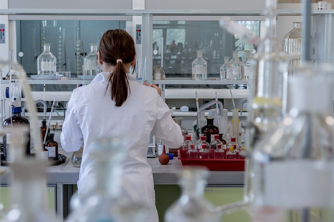 A woman in a lab coat is working in a laboratory.