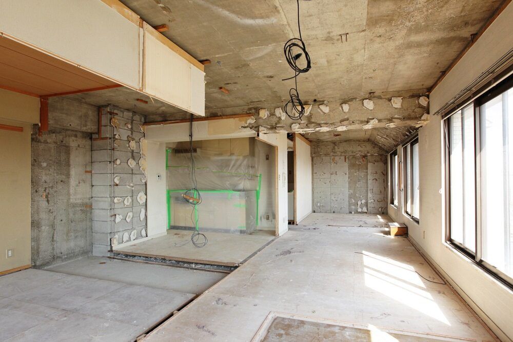 A Large Empty Room With a Lot of Windows and a Concrete Ceiling — Sigley Electrical in Wooli, NSW