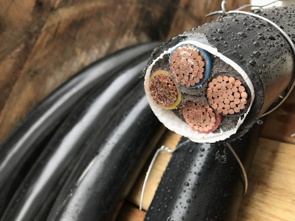 A Close Up of a Black Cable With Copper Wires — Sigley Electrical in Mooball, NSW