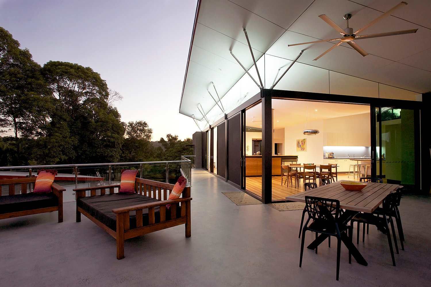 A Balcony With a Table and Chairs and a Ceiling Fan — Sigley Electrical in Mooball, NSW