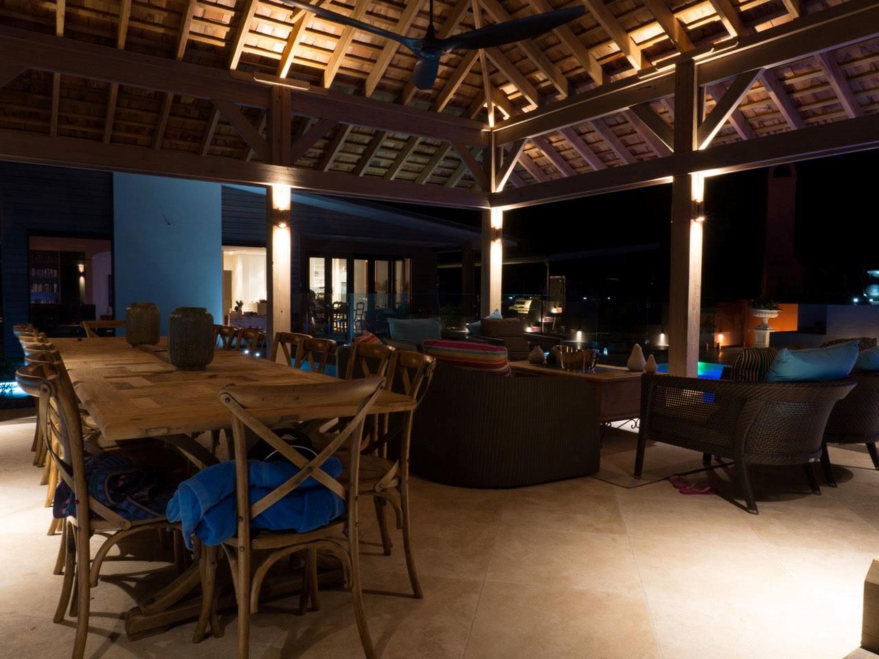 A Dining Room With a Table and Chairs at Night — Sigley Electrical in Mooball, NSW