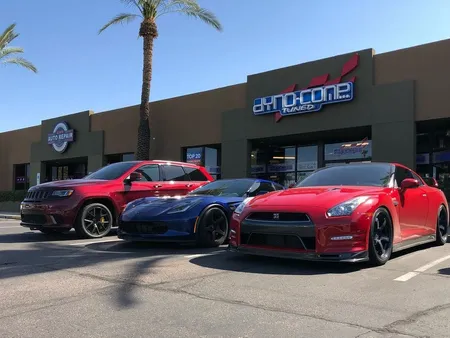 Three cars are parked in front of Dyno-Comp in Scottsdale, AZ