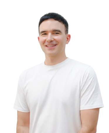 a man in a white t-shirt is standing in front of a white background .