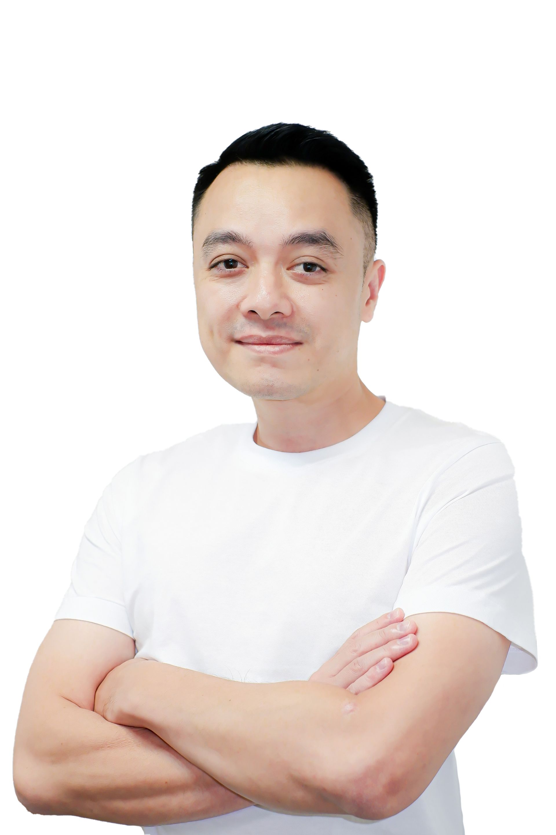 a man in a white shirt is standing with his arms crossed .