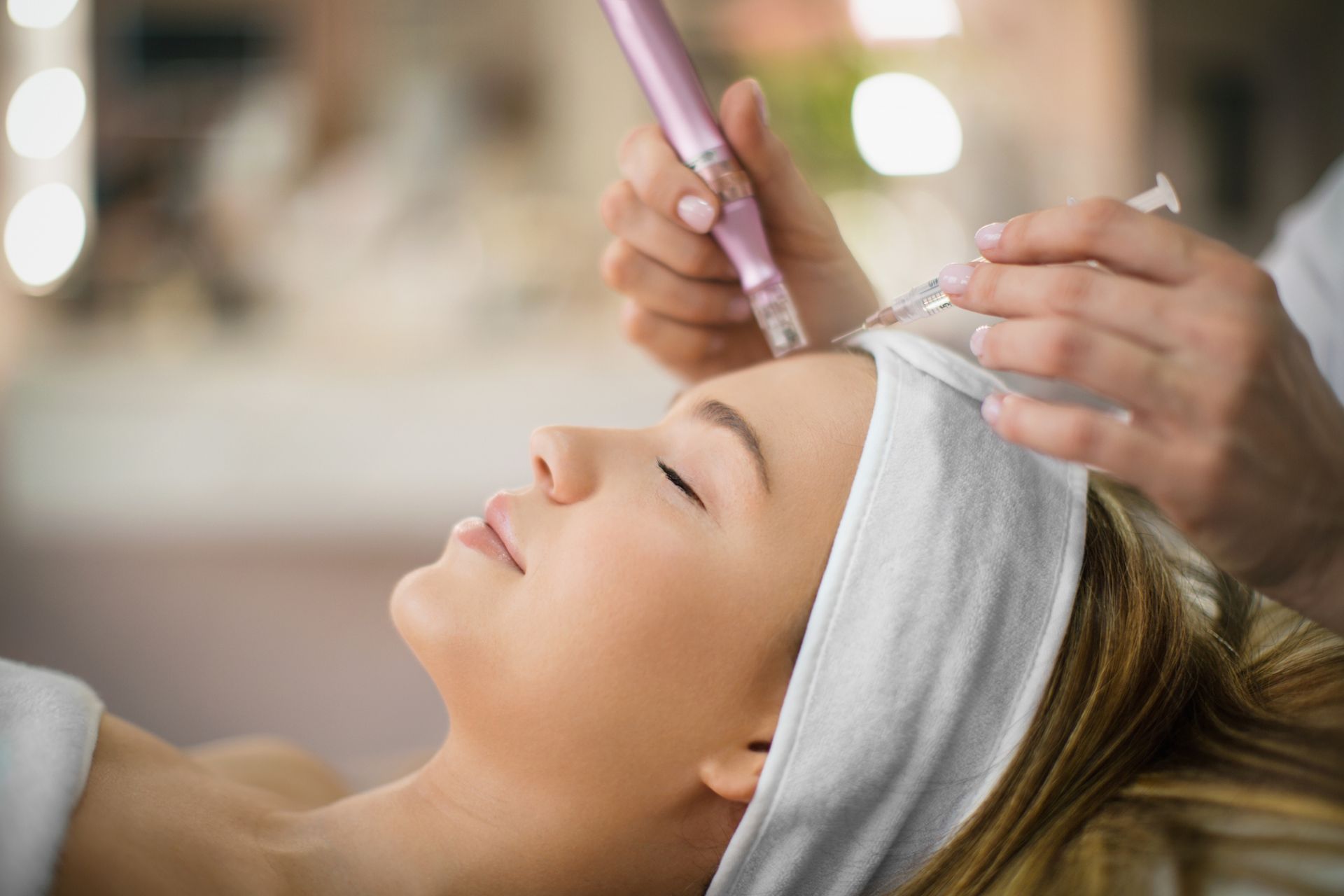 A woman is getting a facial treatment at a beauty salon.