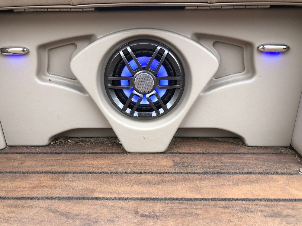 There is a speaker in the back of a boat.