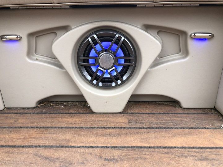 There is a speaker in the back of a boat.