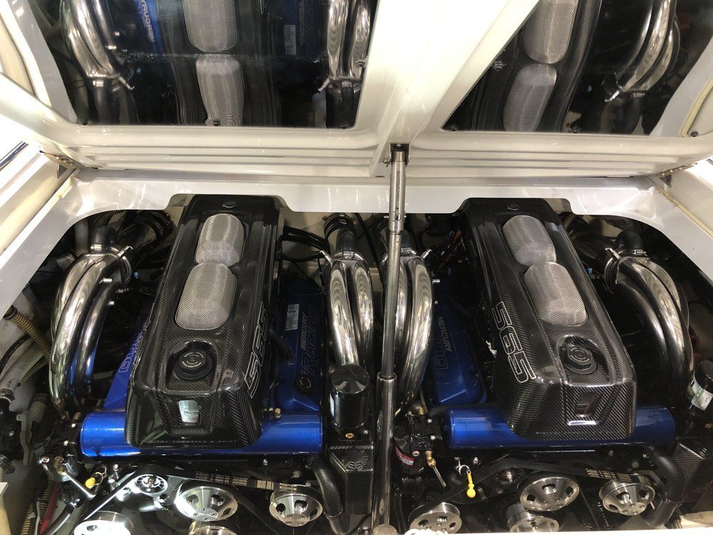 A close up of a boat engine with the hood up.