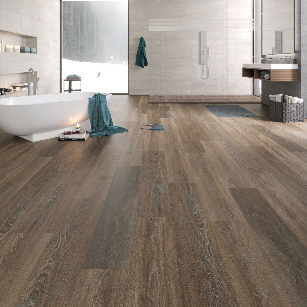 Bathroom with wood-look floor, white tub, shower, and window overlooking snowy scene.