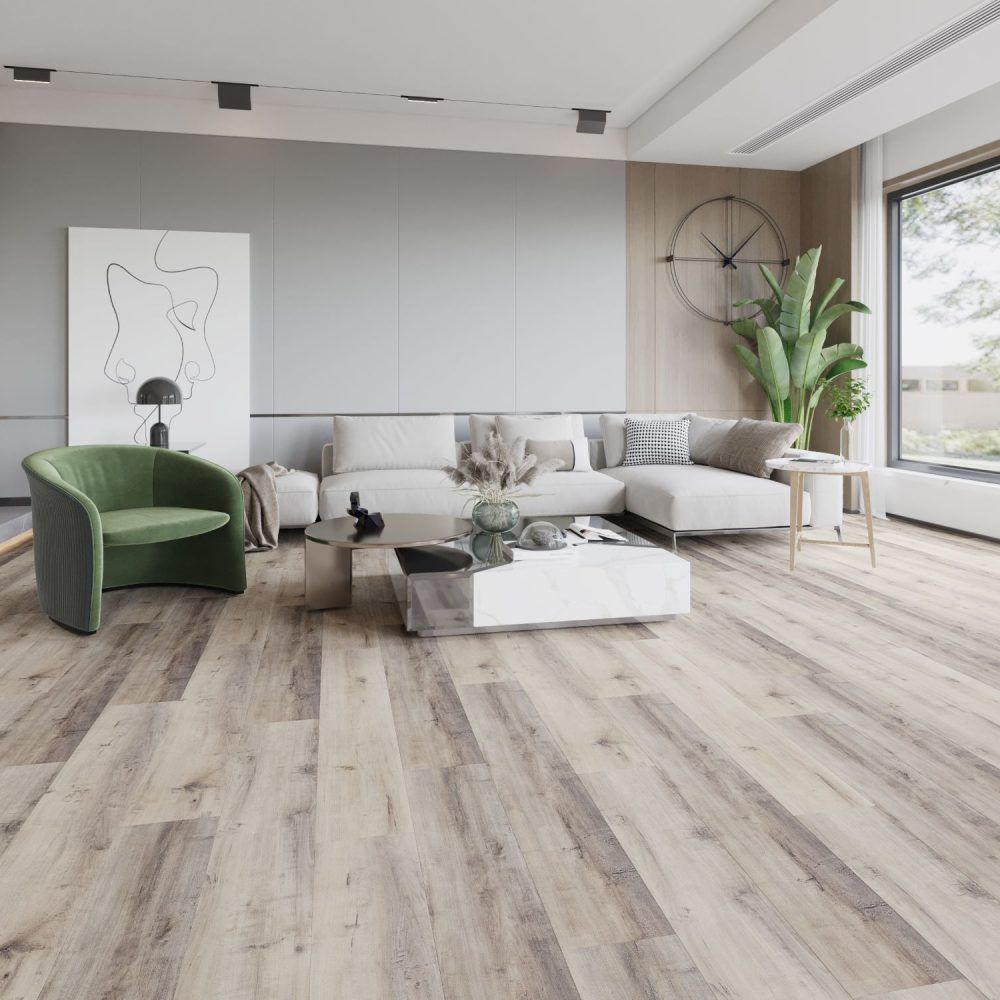 Living room with light wood floors, white sofa, green chair, modern decor. Large window and plant.