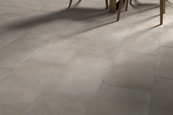 Tan rectangular tiles on floor, partially obscured by shadow and legs of wooden furniture.