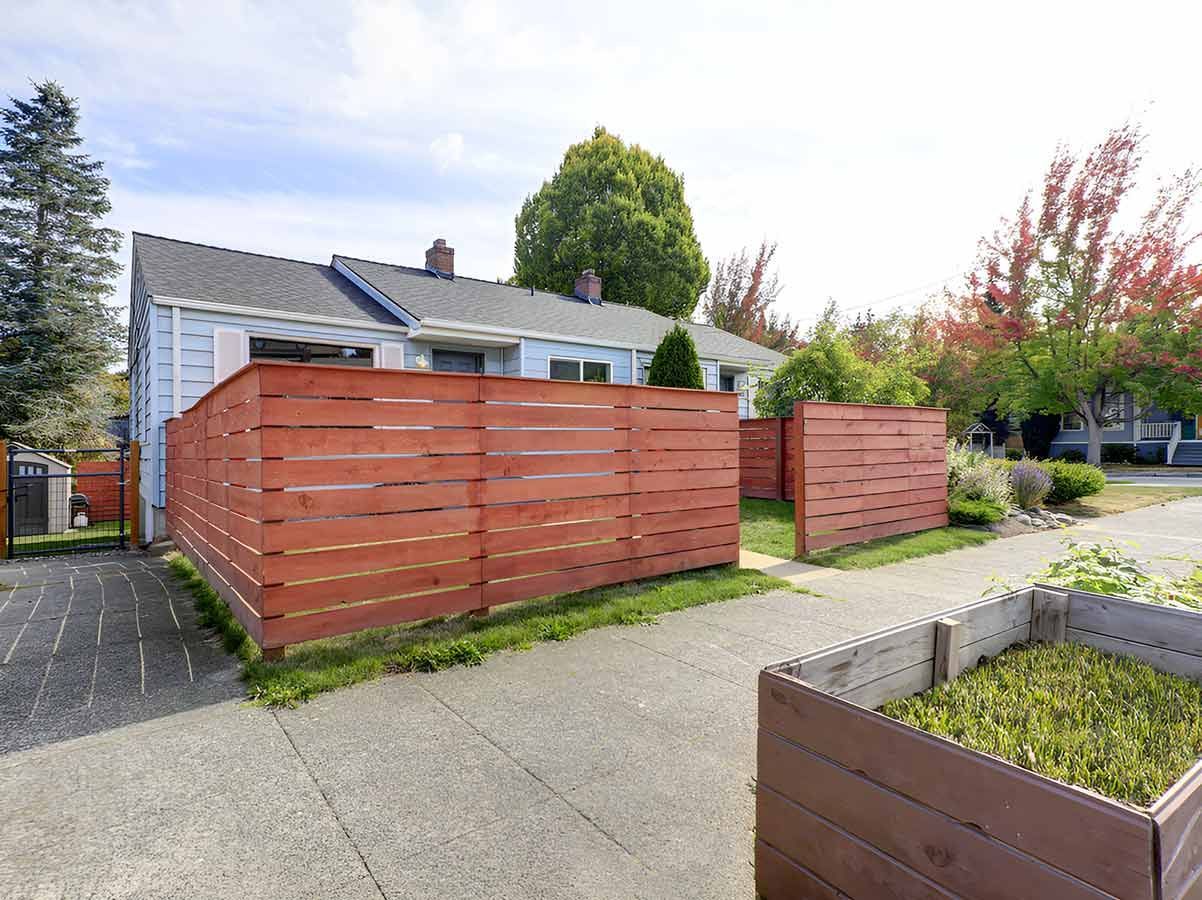A House With a Wooden Fence and a Planter in Front of It — 2 Deadly Timber & Lattice in Mackay, QLD