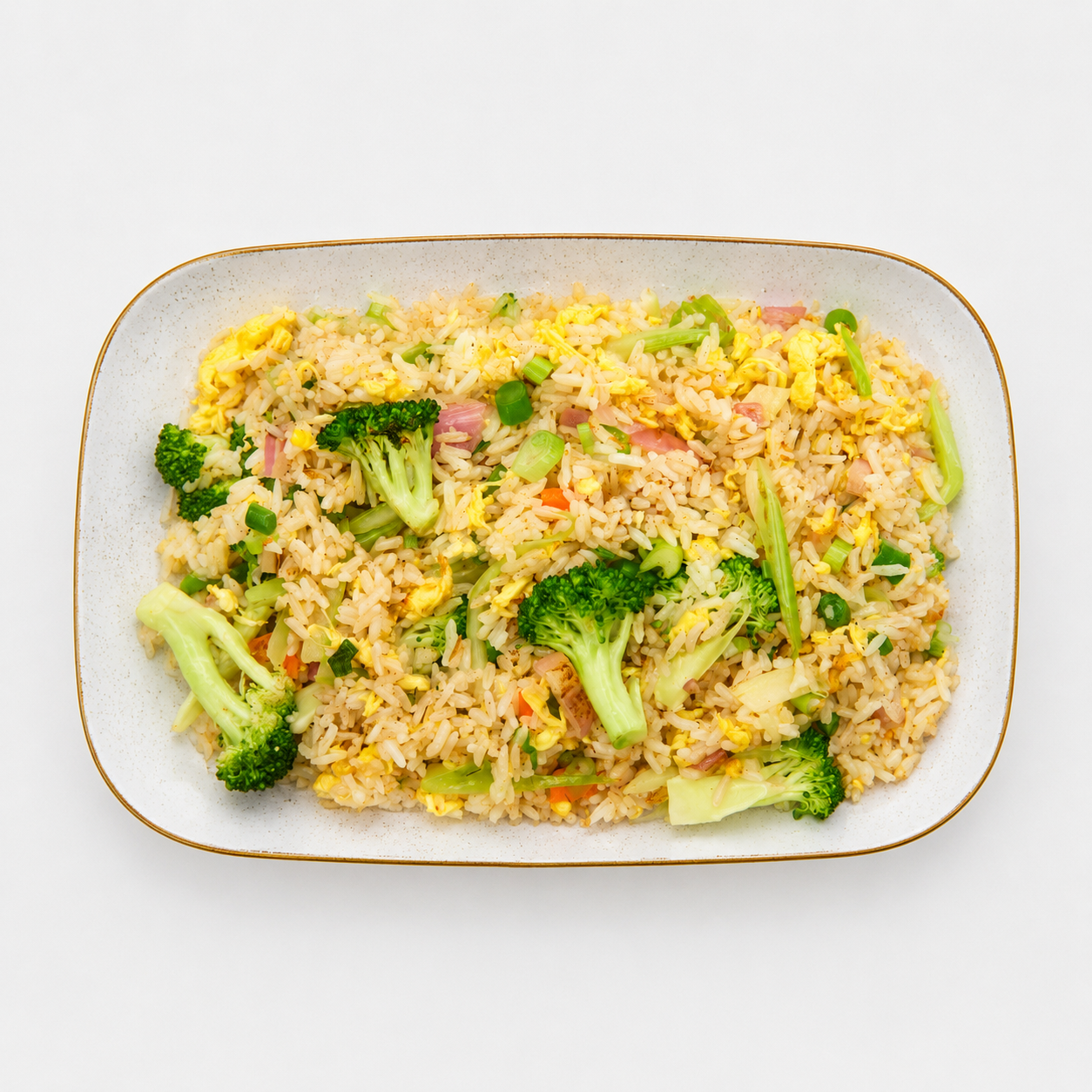 White rectangular dish of fried rice topped with broccoli florets on a light background