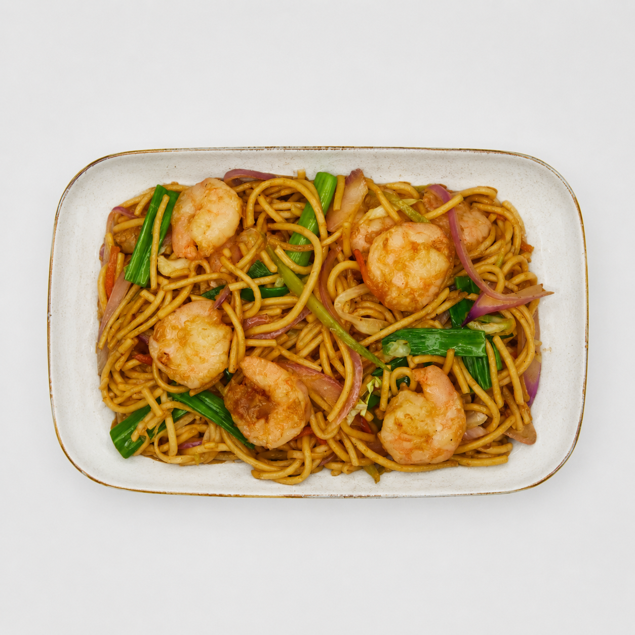 Shrimp lo mein with green onions on a white rectangular plate