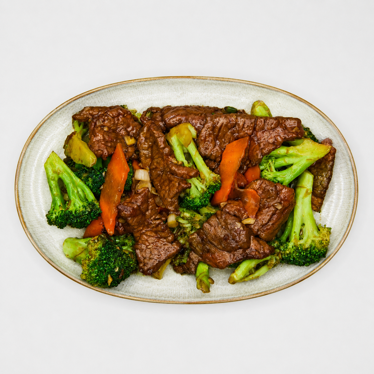 Beef stir-fry with broccoli and carrots on a white plate