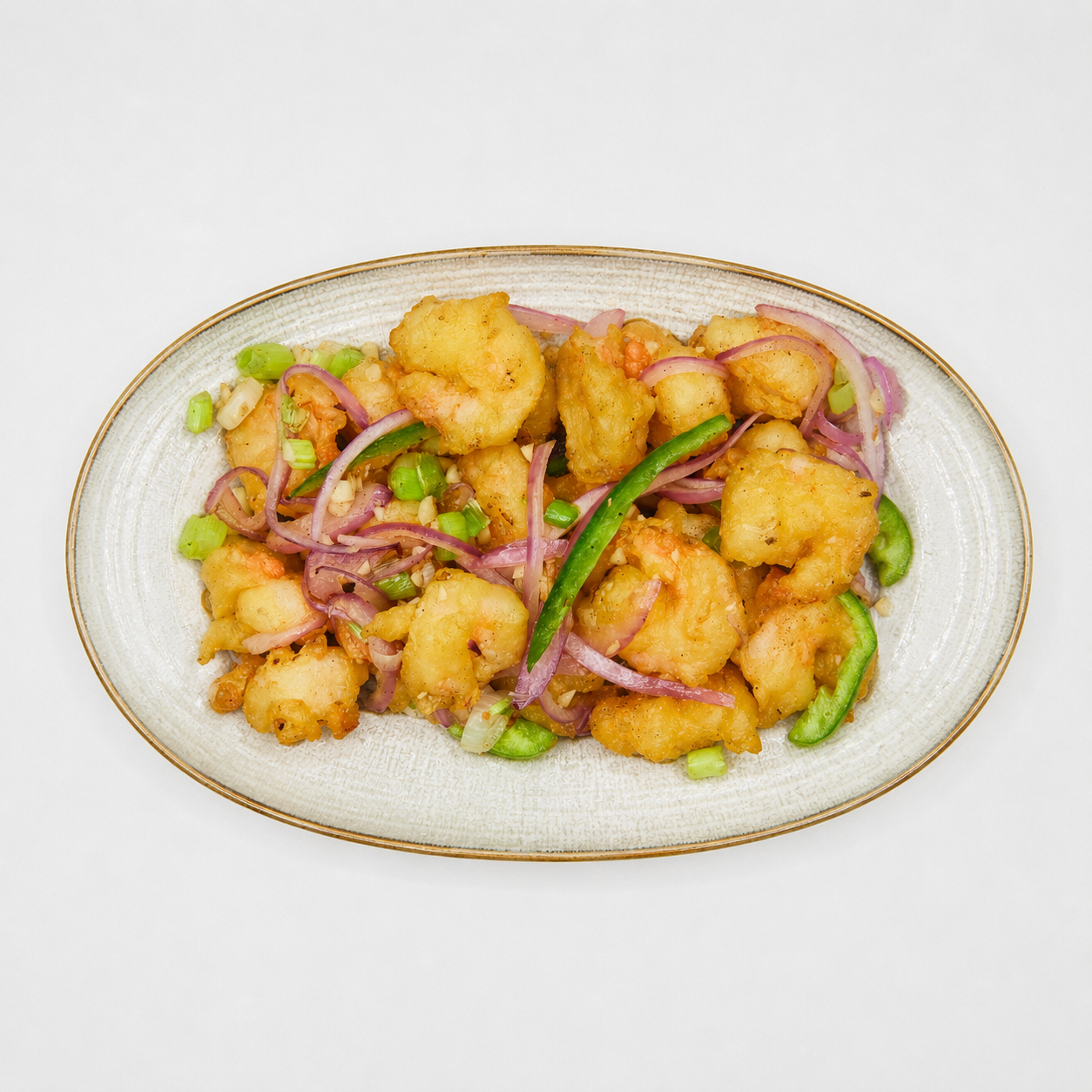 Oven-baked cauliflower florets with peppers and onions on an oval white plate