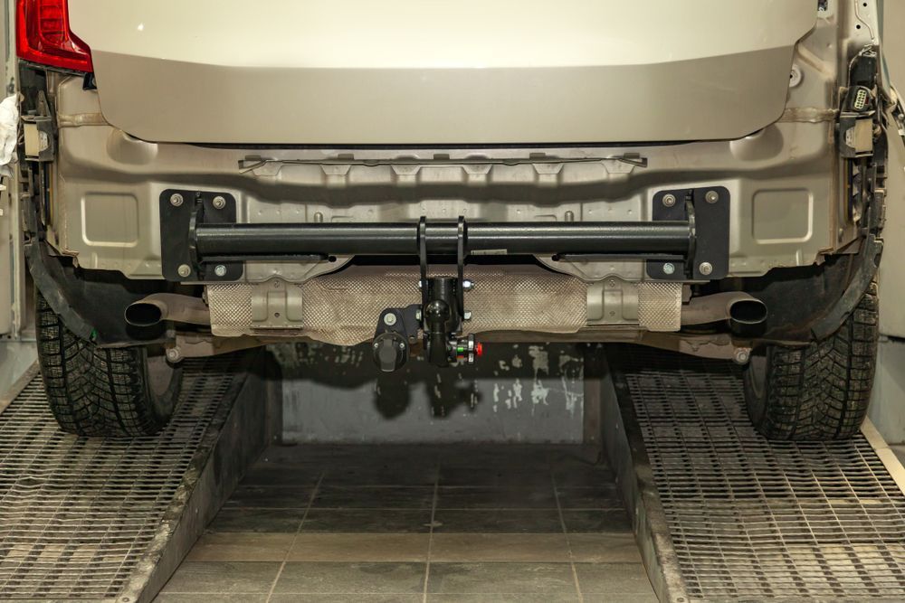 A Car With a Tow Hook Attached to the Back of It is Parked in a Garage — Outlaw Mechanical & Performance In Inverell, NSW