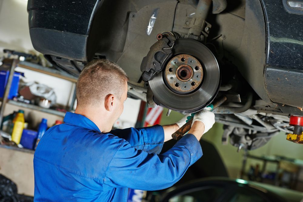 A Man is Working on a Car in a Garage — Outlaw Mechanical & Performance In Inverell, NSW