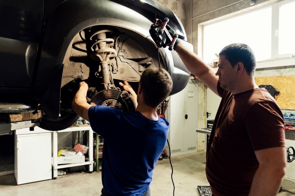Two Men Are Working on a Car in a Garage — Outlaw Mechanical & Performance In Inverell, NSW