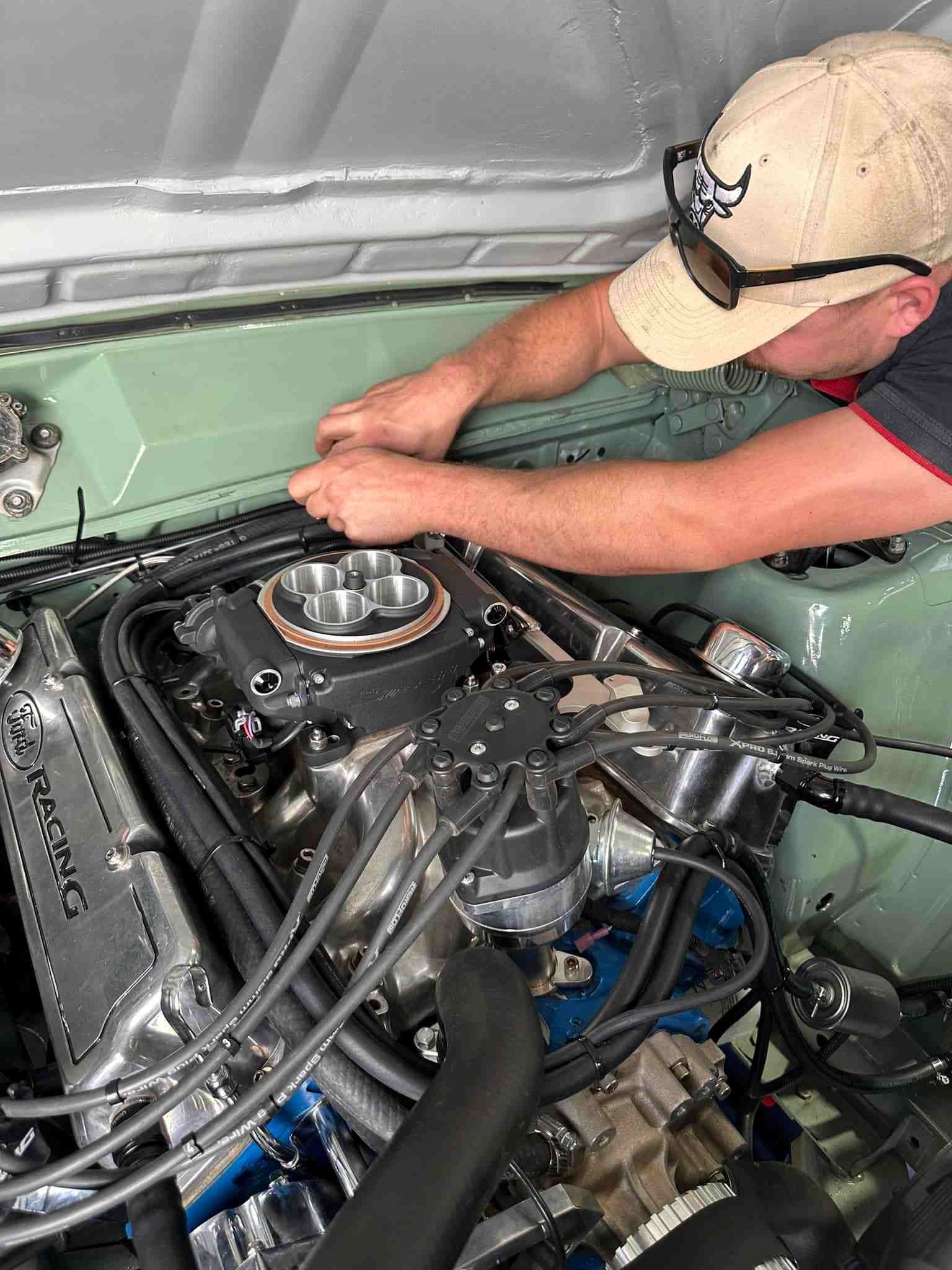 A Man is Working on a Large Engine in a Garage — Outlaw Mechanical & Performance In Inverell, NSW