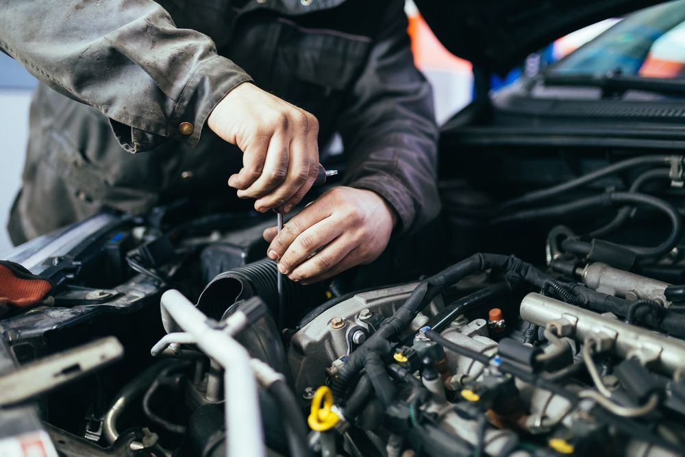 A Man is Working on the Engine of a Car — Outlaw Mechanical & Performance In Inverell, NSW