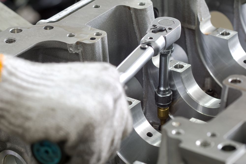 A Person is Working on a Piece of Metal With a Wrench — Outlaw Mechanical & Performance In Inverell, NSW