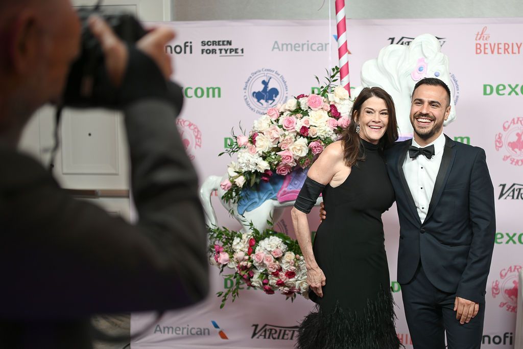 CDF Executive Director Dana Davis poses on the Carousel of Hope red carpet with a male friend.