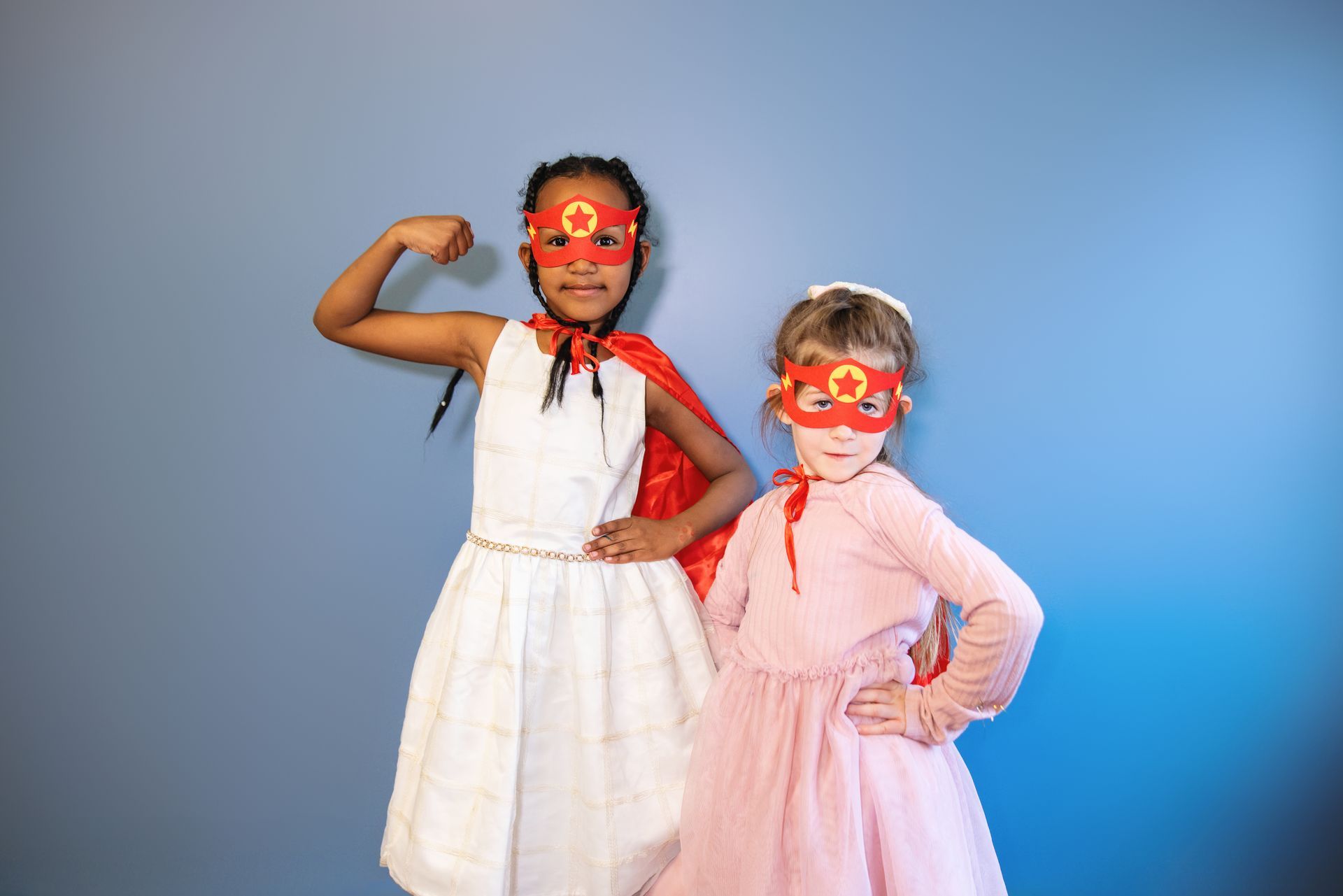 Two young female T1D patients posing in superhero Halloween masks.