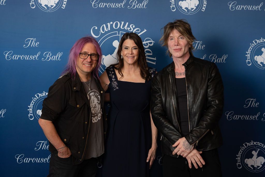 Executive Director of CDF, Dana Davis, flanked by the Goo Goo Dolls on the blue carpet