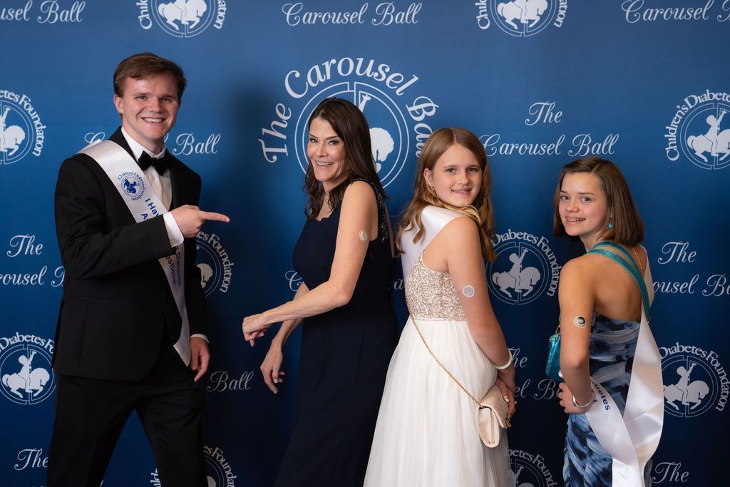 CDF ED Dana Davis posing with t1d advocates on blue carpet 