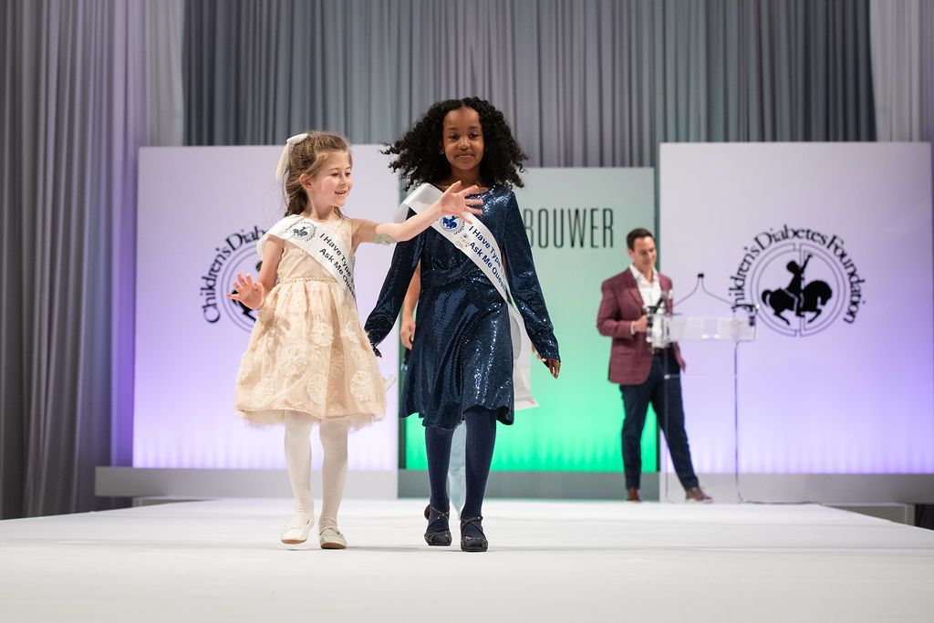Two young CDF advocates on the runway stage during the advocate presentation.