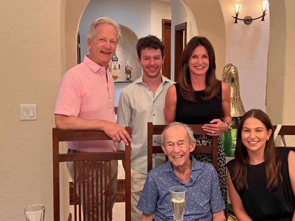 Author Stacy Robinson, her dad, and her husband, son and daughter together and smiling.