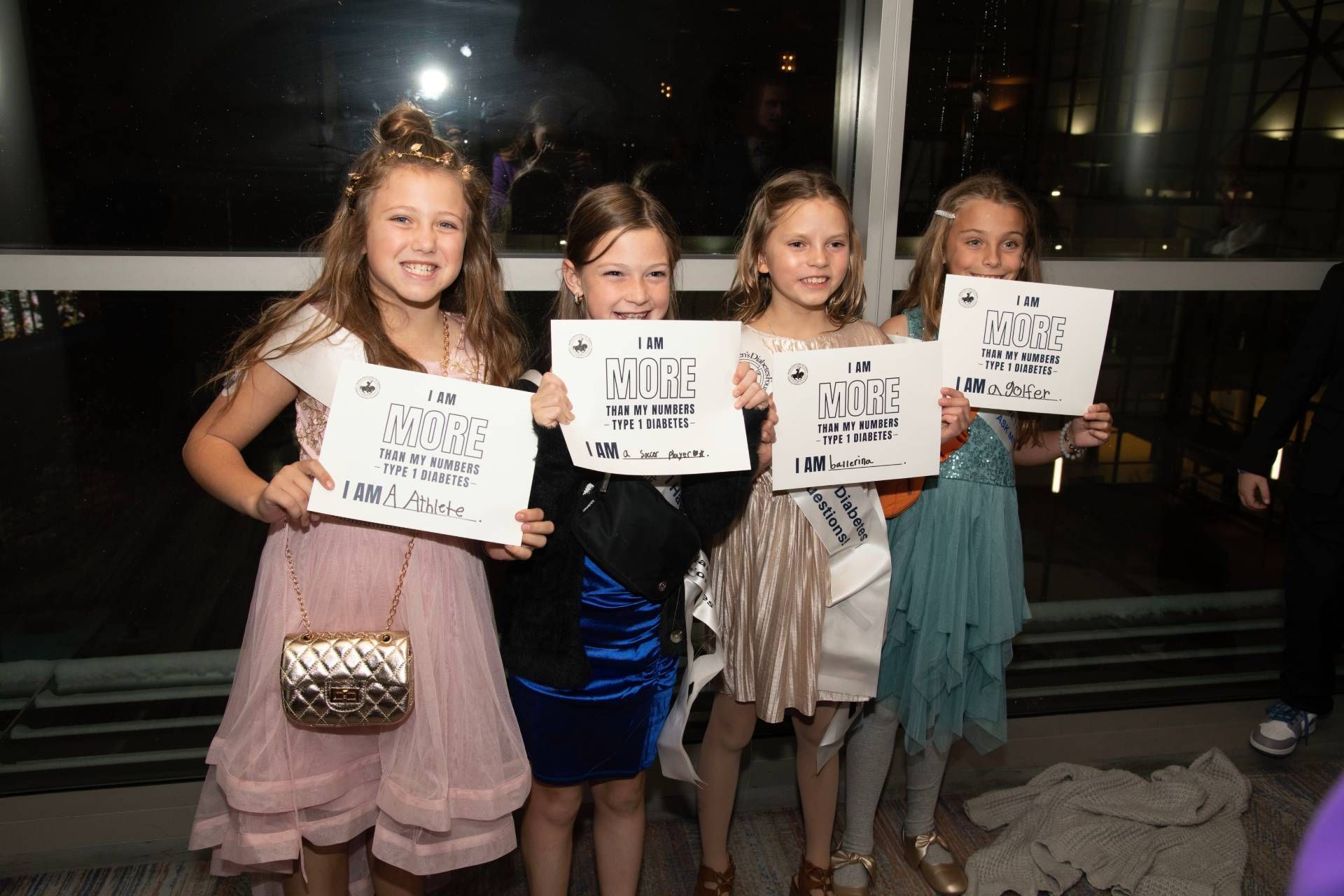 Four young T1D advocate girls holding 
