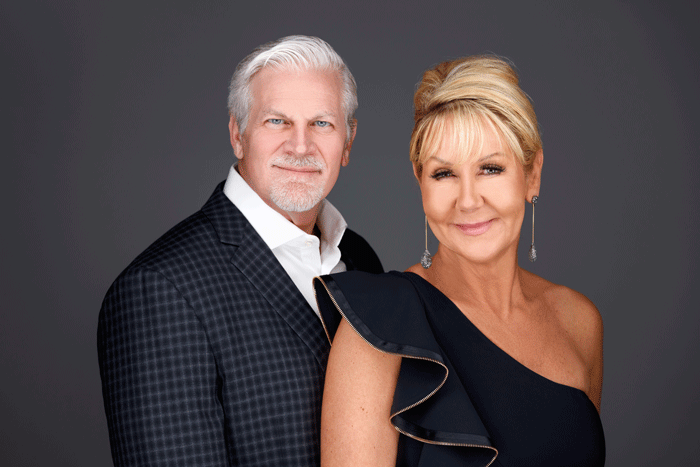 A man and a woman are posing for a picture together.