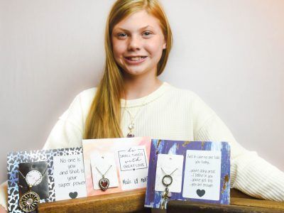 author matti leva posing with several pieces of her jewelry