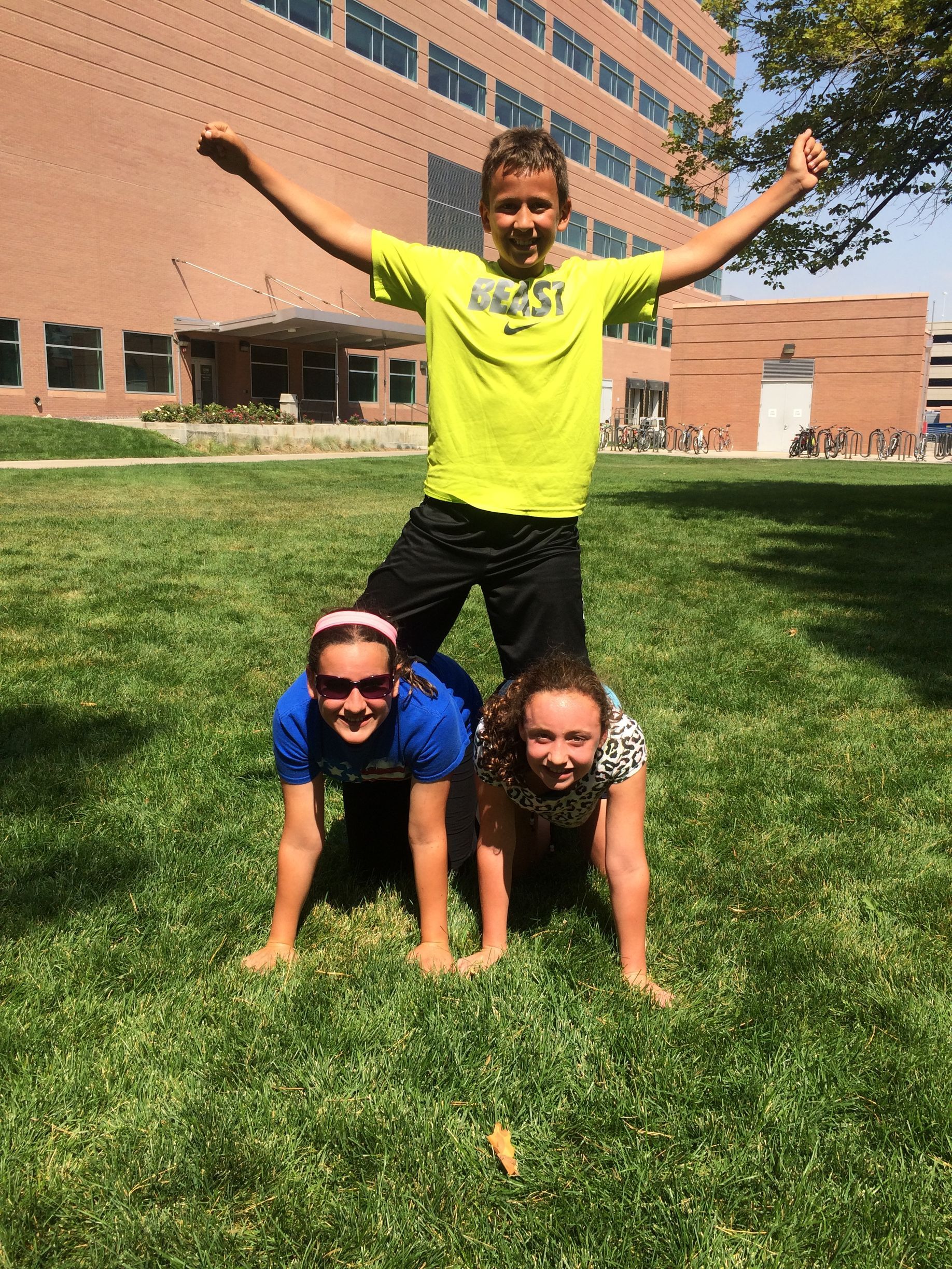 Parker Zarecki on top of a three person pyramid