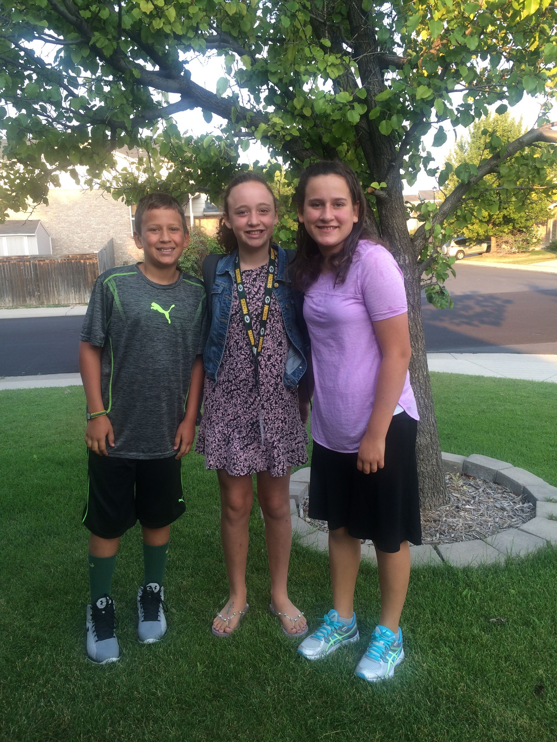 Parker Zarecki and his two sisters posing together and smiling