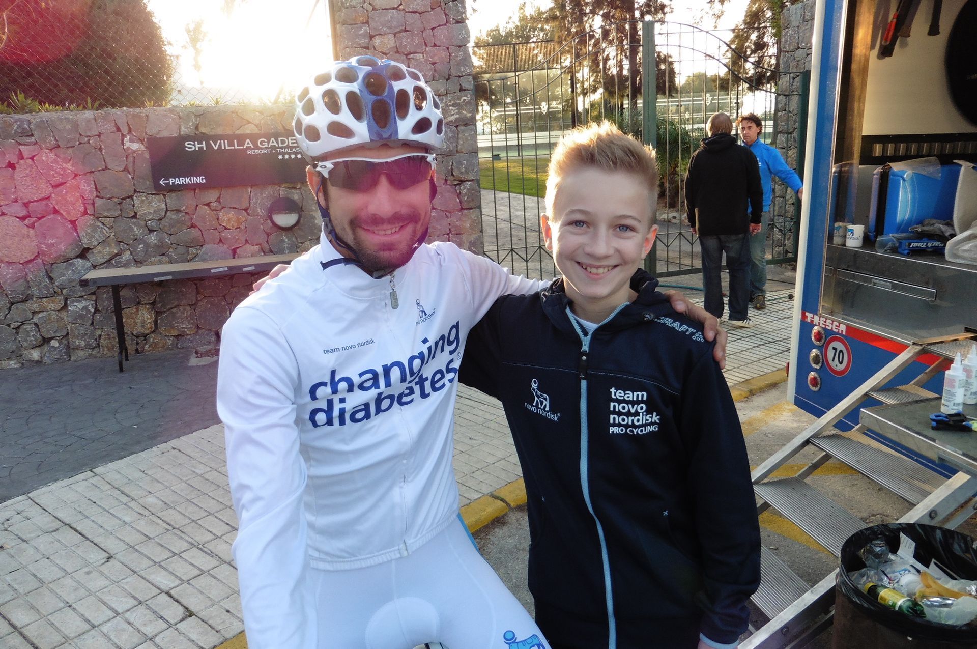 author Zander posing with a member of pro cycling team Novo Nordisk