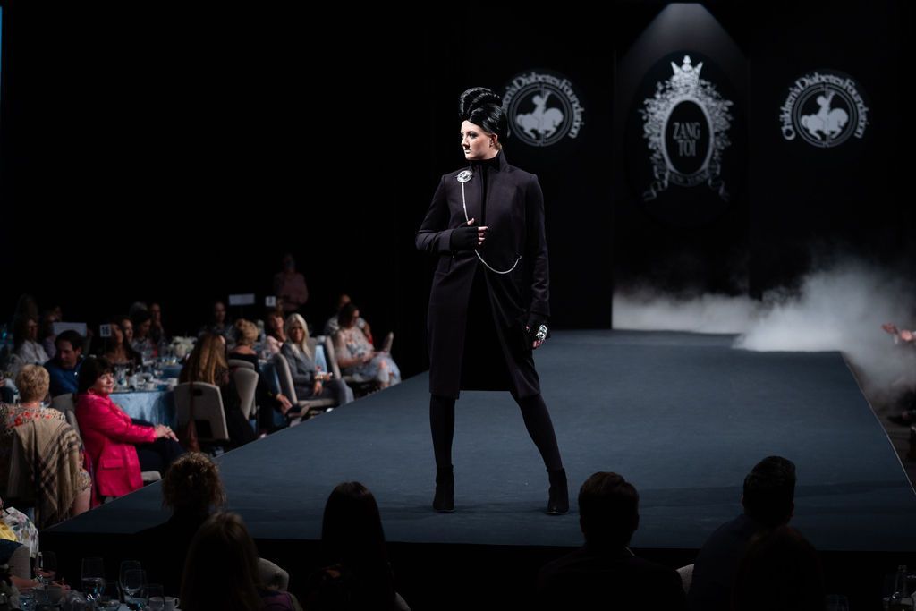 Zang Taoi black long-sleeved dress with silver brooch and chain on runway model