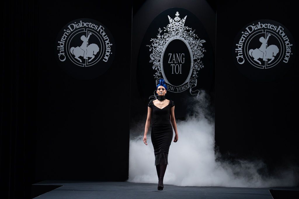 Zang Toi midi black body con dress on model with blue hair on runway