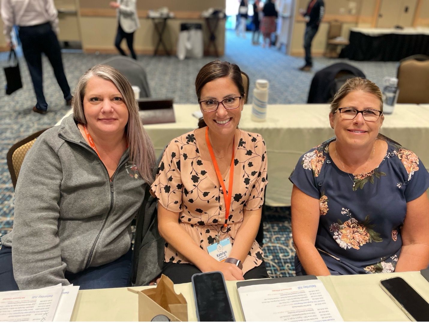 Two female ATDC attendees sitting together and smiling at the conference.