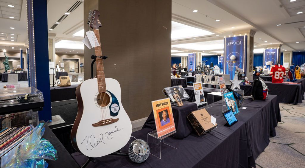 signed neil diamond guitar on display during silent auction