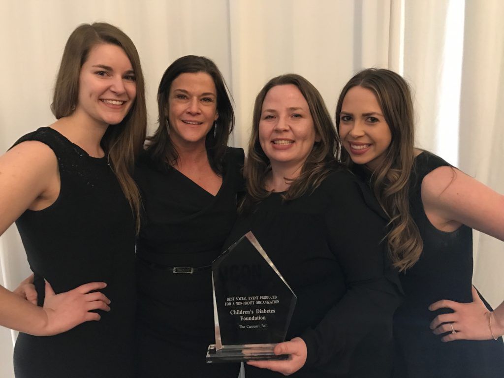 CDF Team (Lto R) Mattie Peck, Dana Davis, Lisa Steele, and Amanda Miller holding their icon award