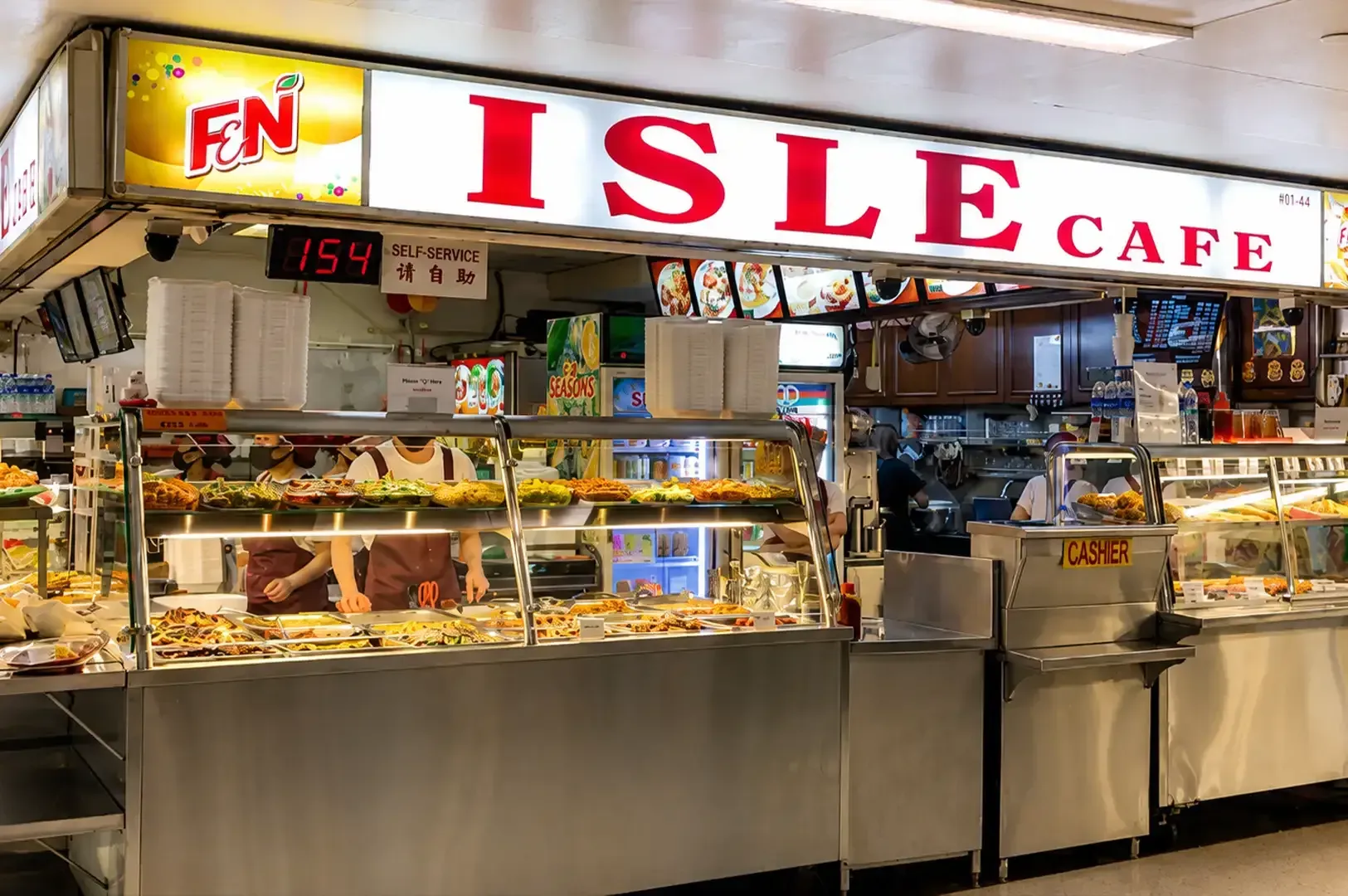 Island Cafe food counter with illuminated sign and glass display cases in a mall setting