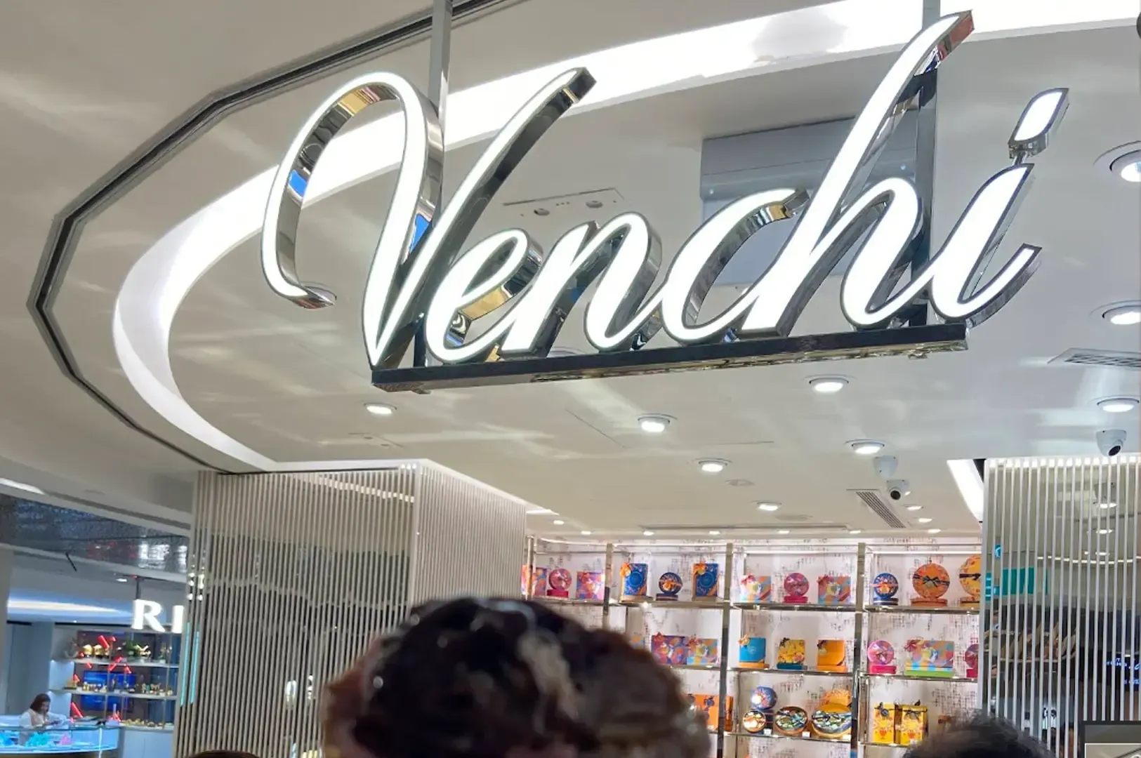 Venchi storefront sign above a brightly lit candy display inside a mall