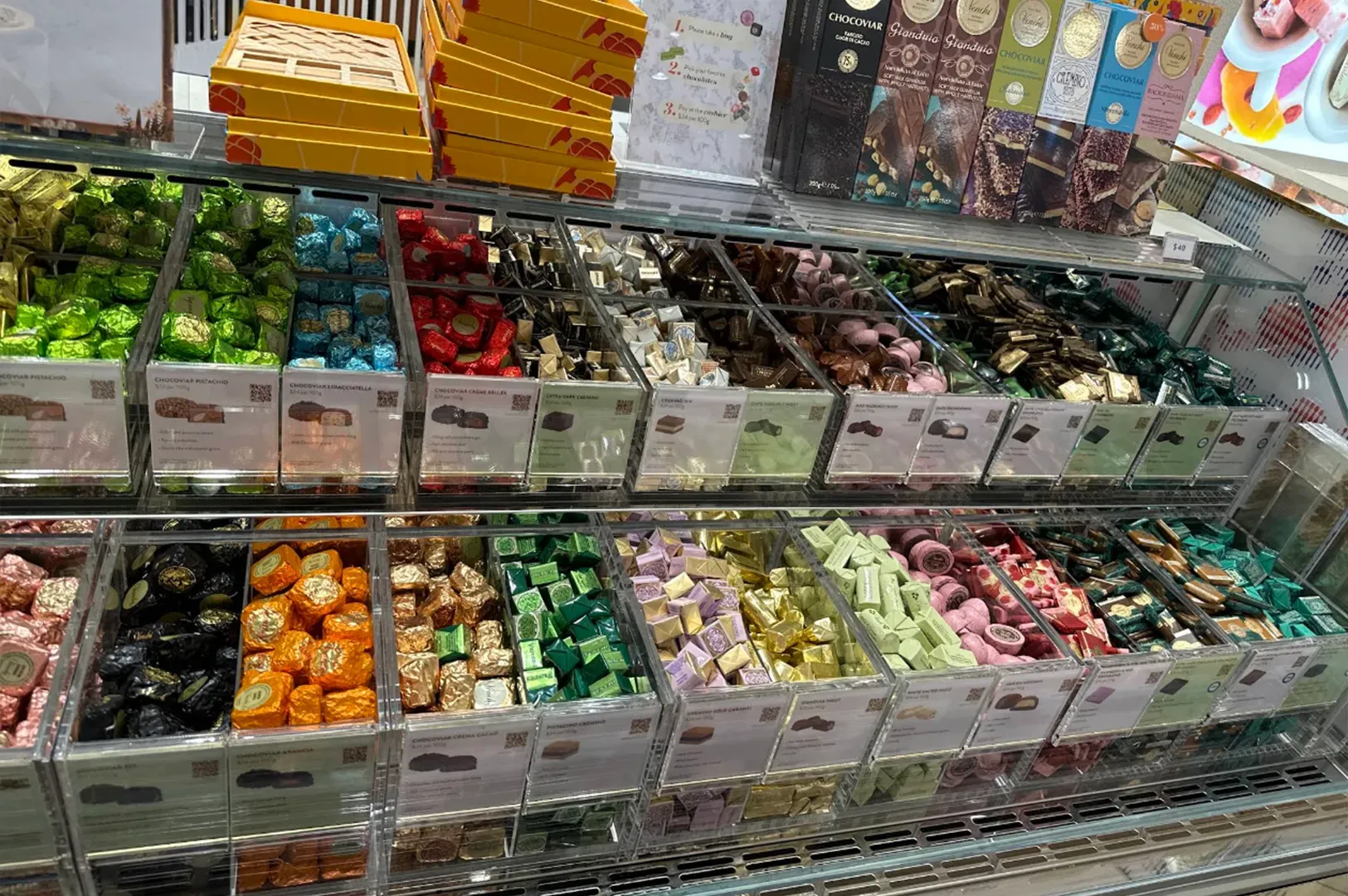 Candy bins filled with colorful assorted sweets in a store display case