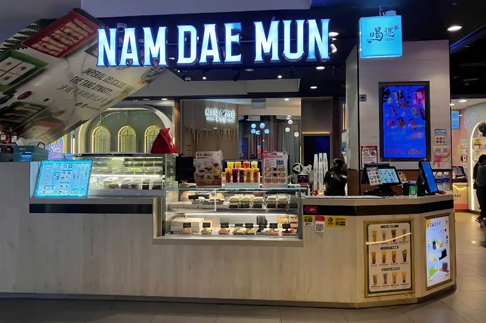 NAMDAE MUN food stall with illuminated sign, glass display cases, and counter in a shopping mall