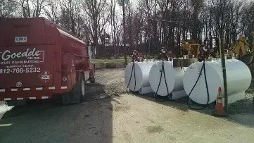 A large white tank with a pump attached to it