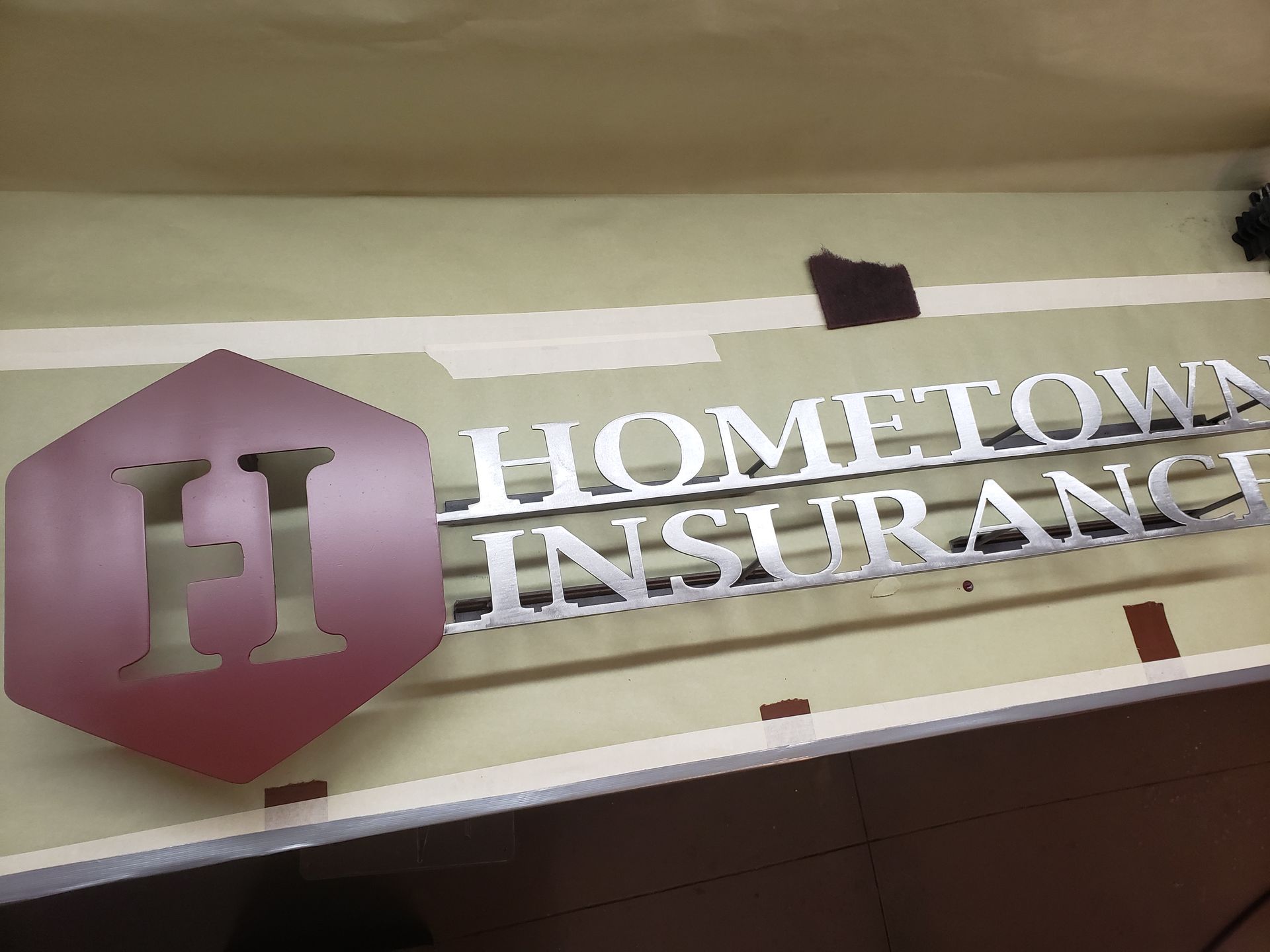 Hometown Insurance sign with a pink hexagon 
